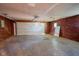 Spacious garage with a large door, and brick walls at 1509 E Centennial Ave, Muncie, IN 47303