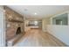 Open living space features a brick fireplace, hardwood floors, and seamless access to the kitchen at 1509 E Centennial Ave, Muncie, IN 47303
