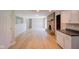 Spacious living area with a brick fireplace, and modern floors, adjacent to the kitchen at 1509 E Centennial Ave, Muncie, IN 47303