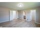Spacious main bedroom featuring wood-look flooring and multiple closets and access to ensuite bath at 1509 E Centennial Ave, Muncie, IN 47303