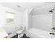 This updated bathroom offers a shower-tub and stylish tile surround at 1521 Lawton Ave, Indianapolis, IN 46203