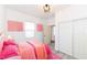 Bright bedroom with pink decor, closet and natural light at 1521 Lawton Ave, Indianapolis, IN 46203