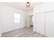 Comfortable bedroom with new laminate floors, freshly painted walls, closet, and modern lighting at 1521 Lawton Ave, Indianapolis, IN 46203