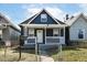 Charming home featuring a covered porch, white trim, and a quaint front yard, offering curb appeal at 1521 Lawton Ave, Indianapolis, IN 46203
