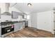 Galley kitchen has stainless steel appliances and lots of light at 1521 Lawton Ave, Indianapolis, IN 46203