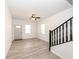 Bright, open living area featuring modern flooring, fresh paint, and staircase, creating a welcoming atmosphere at 1521 Lawton Ave, Indianapolis, IN 46203