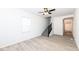 Airy living room boasts new laminate flooring, neutral walls, and stairway to upper level with plenty of room at 1521 Lawton Ave, Indianapolis, IN 46203