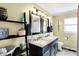 Elegant bathroom with a double sink vanity, stylish mirrors, and modern fixtures at 15415 E 146Th St, Noblesville, IN 46060