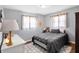 Bedroom with hard wood floors, gray walls, two windows, dresser and décor at 15415 E 146Th St, Noblesville, IN 46060