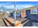 Inviting front porch with seating area and vibrant orange door, perfect for relaxing outdoors at 15415 E 146Th St, Noblesville, IN 46060