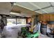 Spacious garage featuring a lawn mower, truck view, ample lighting, and storage space at 15415 E 146Th St, Noblesville, IN 46060