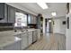 Bright kitchen boasts stainless steel appliances, grey cabinets, and stylish countertop at 15415 E 146Th St, Noblesville, IN 46060