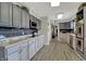 Open-concept kitchen featuring stainless appliances, grey cabinets and tile backsplash at 15415 E 146Th St, Noblesville, IN 46060
