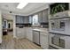 Updated kitchen features stainless steel appliances, grey cabinets, and tiled backsplash at 15415 E 146Th St, Noblesville, IN 46060