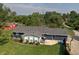 Lovely backyard view showcasing a charming blue home, patio, and basketball hoop at 15415 E 146Th St, Noblesville, IN 46060