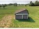 Functional outdoor shed with roll up doors on a lush green lawn at 15415 E 146Th St, Noblesville, IN 46060