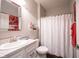 Clean bathroom showcasing vanity, toilet, and shower with patterned curtain at 16164 Loire Valley Dr, Fishers, IN 46037