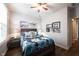 Comfortable bedroom features warm colors, ceiling fan and artwork adding charm to the space at 16164 Loire Valley Dr, Fishers, IN 46037