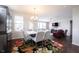 Stylish dining area seamlessly connects to the living room, with a colorful rug and contemporary decor at 16164 Loire Valley Dr, Fishers, IN 46037
