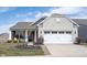 Charming home featuring stone accents, two-car garage, and manicured front lawn adding curb appeal at 16164 Loire Valley Dr, Fishers, IN 46037