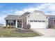 Charming home with a stone and brick facade, featuring a well-manicured lawn and attached garage at 16164 Loire Valley Dr, Fishers, IN 46037