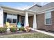 Inviting front porch with stylish furniture and landscaping, creating a welcoming entrance to the home at 16164 Loire Valley Dr, Fishers, IN 46037