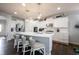 Well-lit kitchen features a large island with seating, modern appliances, and hardwood floors at 16164 Loire Valley Dr, Fishers, IN 46037