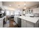 Spacious kitchen boasts a large island and stainless steel appliances overlooking the dining and living areas at 16164 Loire Valley Dr, Fishers, IN 46037