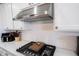 Close-up of KitchenAid vent over gas stove and backsplash at 16164 Loire Valley Dr, Fishers, IN 46037