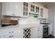 Close up of the kitchen's stunning wet bar, showing white cabinetry, wine rack, and cooler at 16164 Loire Valley Dr, Fishers, IN 46037