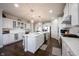 Bright, open kitchen features a large island, stainless steel appliances, and white cabinetry at 16164 Loire Valley Dr, Fishers, IN 46037