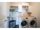 Well-equipped laundry room features modern appliances, built-in storage, and ample workspace at 16164 Loire Valley Dr, Fishers, IN 46037