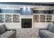 Cozy library with built-in bookshelves, a fireplace, and comfortable armchairs at 16164 Loire Valley Dr, Fishers, IN 46037