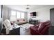 Cozy living room with comfortable seating, a fireplace, and a large TV at 16164 Loire Valley Dr, Fishers, IN 46037