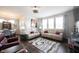 Bright living room features hardwood floors, large windows, and modern furnishings at 16164 Loire Valley Dr, Fishers, IN 46037