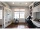 Bright office featuring built-in shelving, large window, and glass paneled doors at 16164 Loire Valley Dr, Fishers, IN 46037