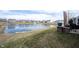 Picturesque pond view with fountain and surrounding homes, offering a serene neighborhood setting at 16164 Loire Valley Dr, Fishers, IN 46037