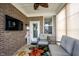 Cozy sunroom includes a television, comfortable seating, and large windows with a tropical theme at 16164 Loire Valley Dr, Fishers, IN 46037