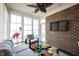 Bright sunroom featuring comfortable seating, large windows, and a ceiling fan at 16164 Loire Valley Dr, Fishers, IN 46037