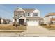 Beautiful two-story home featuring a blend of stone and siding, a two car garage and a well-manicured lawn at 18108 Cristin Cir, Westfield, IN 46062