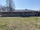 Back exterior of a brick and stone house with a large yard and covered patio at 224 Griffin Rd, Indianapolis, IN 46227