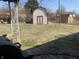 Large backyard featuring two storage sheds and a partially covered patio area at 224 Griffin Rd, Indianapolis, IN 46227