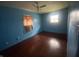 Bright bedroom with wood floors, a ceiling fan, and a window providing natural light at 224 Griffin Rd, Indianapolis, IN 46227