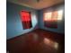 Well-lit bedroom featuring dark floors, light blue walls, and two windows at 224 Griffin Rd, Indianapolis, IN 46227