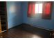 Cozy bedroom with dark wood flooring, light blue walls, and a closet at 224 Griffin Rd, Indianapolis, IN 46227