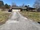 Ranch style home, attached garage, and long driveway on a sunny day at 224 Griffin Rd, Indianapolis, IN 46227