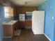 Functional kitchen with wood cabinets, white appliances, and a large sink area at 224 Griffin Rd, Indianapolis, IN 46227