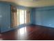 Comfortable living room featuring wood-look floors, light blue walls and well-lit windows at 224 Griffin Rd, Indianapolis, IN 46227