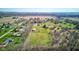 Overhead view of a neighborhood and an estate with large manicured lawn, pool, and detached garage at 2274 W Huntsville Rd, Pendleton, IN 46064