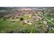 An aerial view of a single-Gathering home, an in-ground pool, and a detached garage on expansive lawn at 2274 W Huntsville Rd, Pendleton, IN 46064